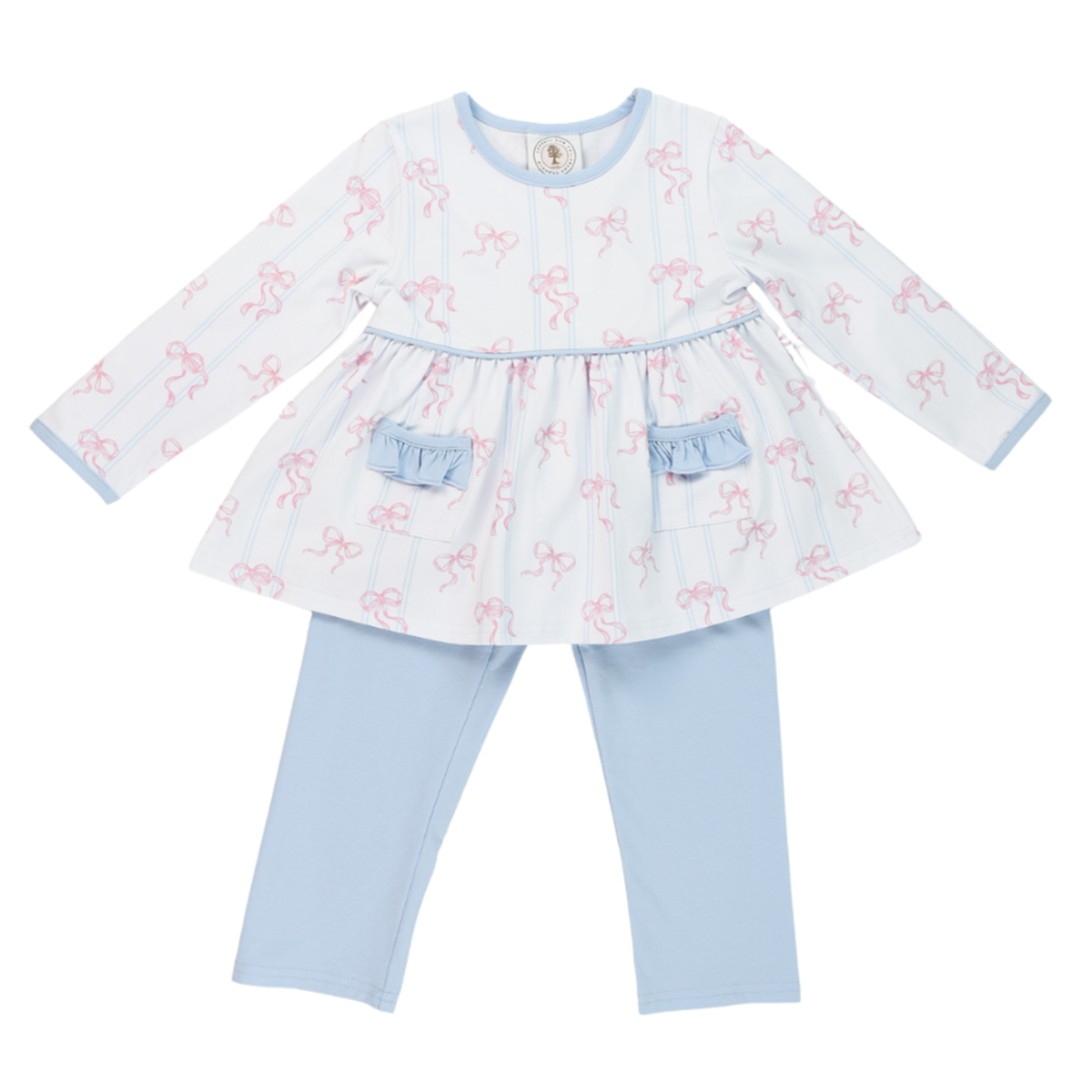 Little girl’s fall or winter outfit with a white top, pink bows design, ruffles, and light blue pants.