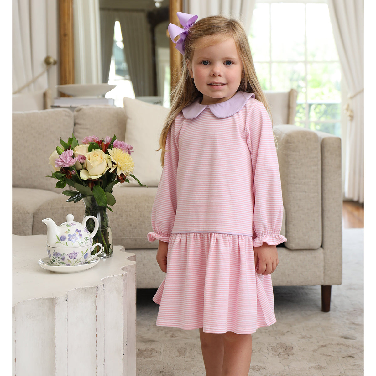 Toddler girl in a pink stripe dropwaist long sleeve dress with lavender collar