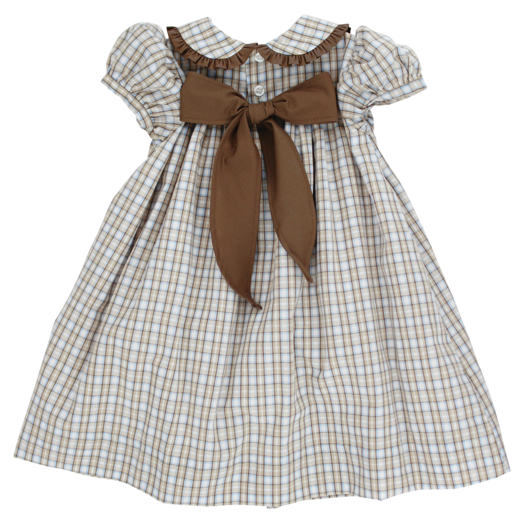 A toddler girl's dress with a beige, tan, blue and brown plaid pattern, featuring a large brown bow at the back.