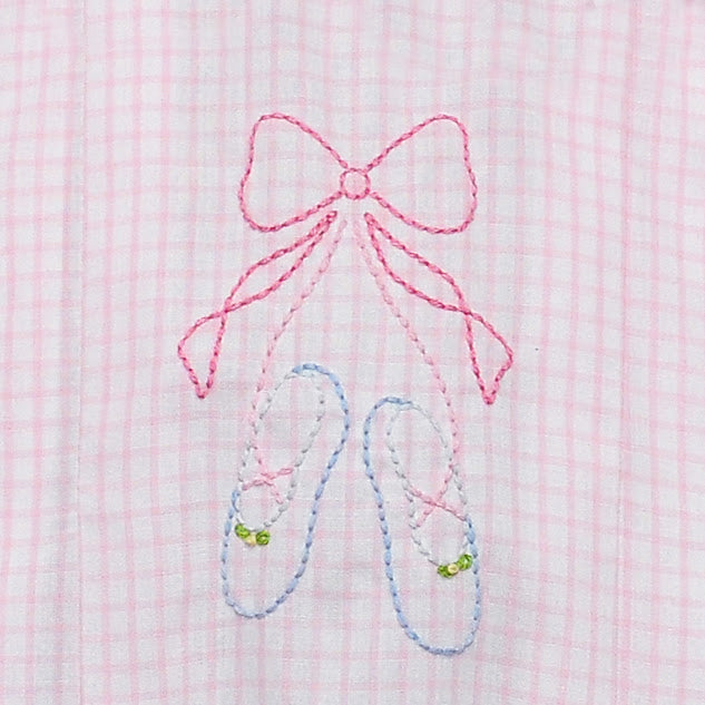 Embroidered pink bow and blue ballet shoes on a pink and white plaid fabric background