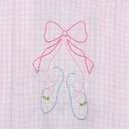 Embroidered pink bow and blue ballet shoes on a pink and white plaid fabric background