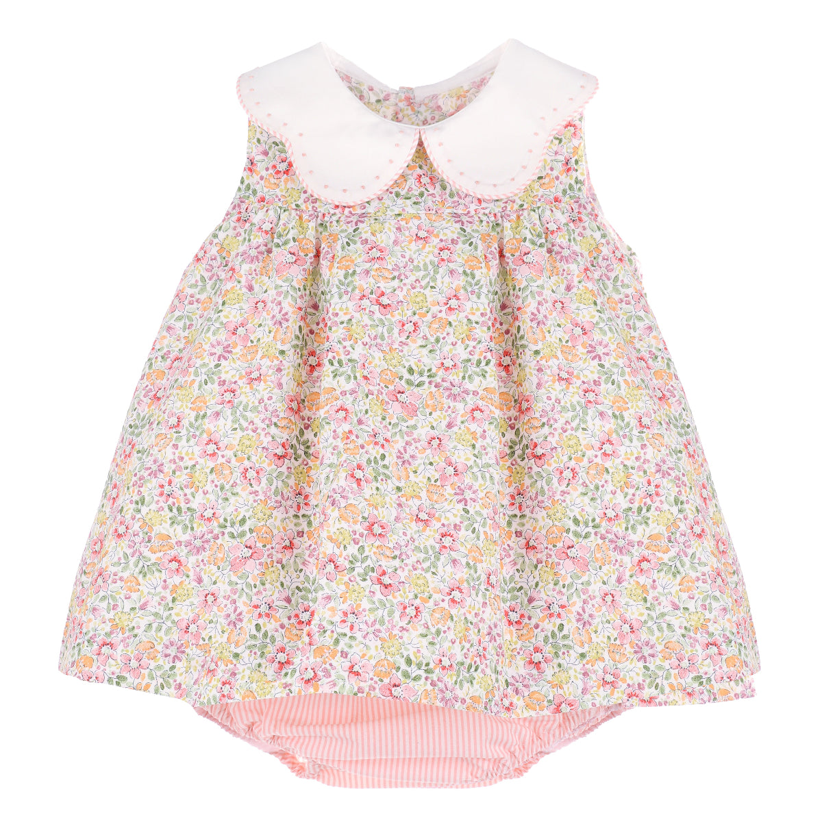 Sleeveless floral dress with a white scalloped collar with embroidered details and a coral stripe diaper cover.