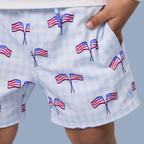 Boys swim trunks with American flag pattern on a checkered background