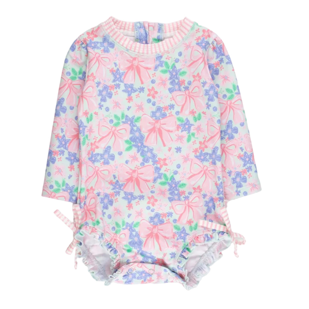 Girls long sleeve rashguard swimsuit with a pink bows and flowers design with bows at the hips.