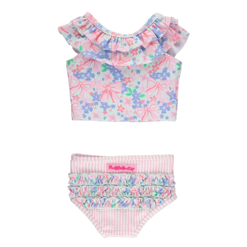 Girls two piece tankini bathing suit with pink striped ruffled bottoms and a ruffled top in a pink bows and flowers print.