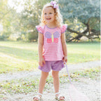 Toddler girl wearing a pink stripe and lavender shorts outfit with a butterfly applique and flutter sleeves.