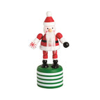Wooden Santa Claus collapsible Christmas toy on a green striped base.