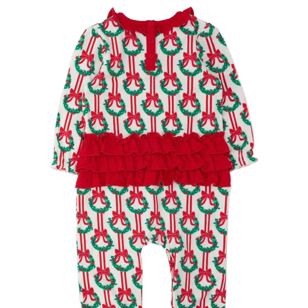 A toddler's holiday-themed long-sleeve romper with an all-over Christmas wreath and bow print on a white base, featuring a prominent red ruffle waistband and red tie detail at the neckline.