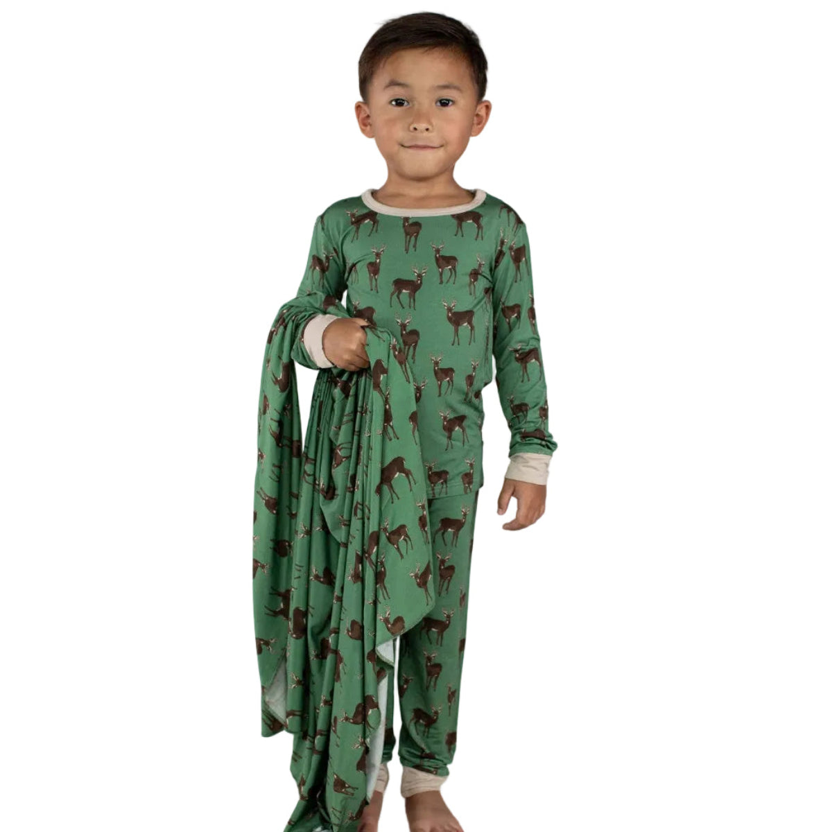 Child wearing a green outfit with deer pattern on a white background