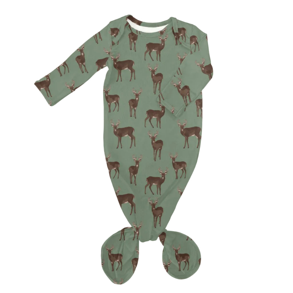 A baby footed sleeper in sage green with an all-over print of brown deer, shown flat on a white background.