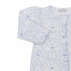 Closeup of a baby girl footie with ruffle trim zip front and blue coquette bows and floral pattern.