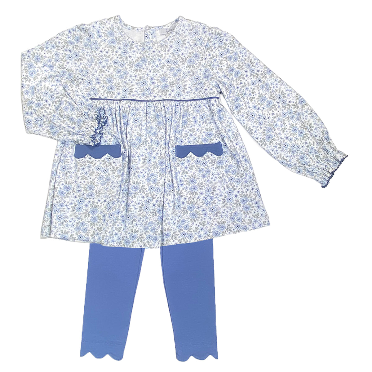 A little girl's two-piece outfit set featuring a long-sleeve tunic top in a blue and white floral patternand scalloped pockets paired with solid blue leggings with matching scalloped hems.