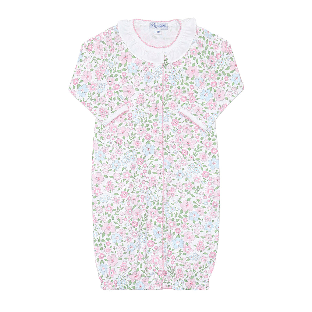 Pastel floral garden print baby girl converter gown with a white ruffle at the neck and pink trim.