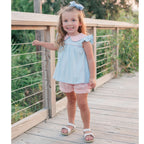 Toddler girl wearing a blue knit top with coral stripe shorts set