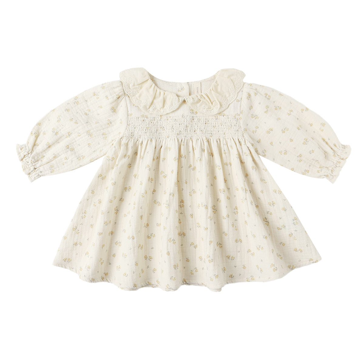 Cream color toddler girl Quincy Mae long sleeve smocked muslin dress with a muted floral pattern and ruffled lace collar.