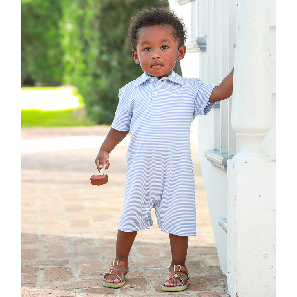 Baby boy wearing a light blue striped knit polo romper with collar