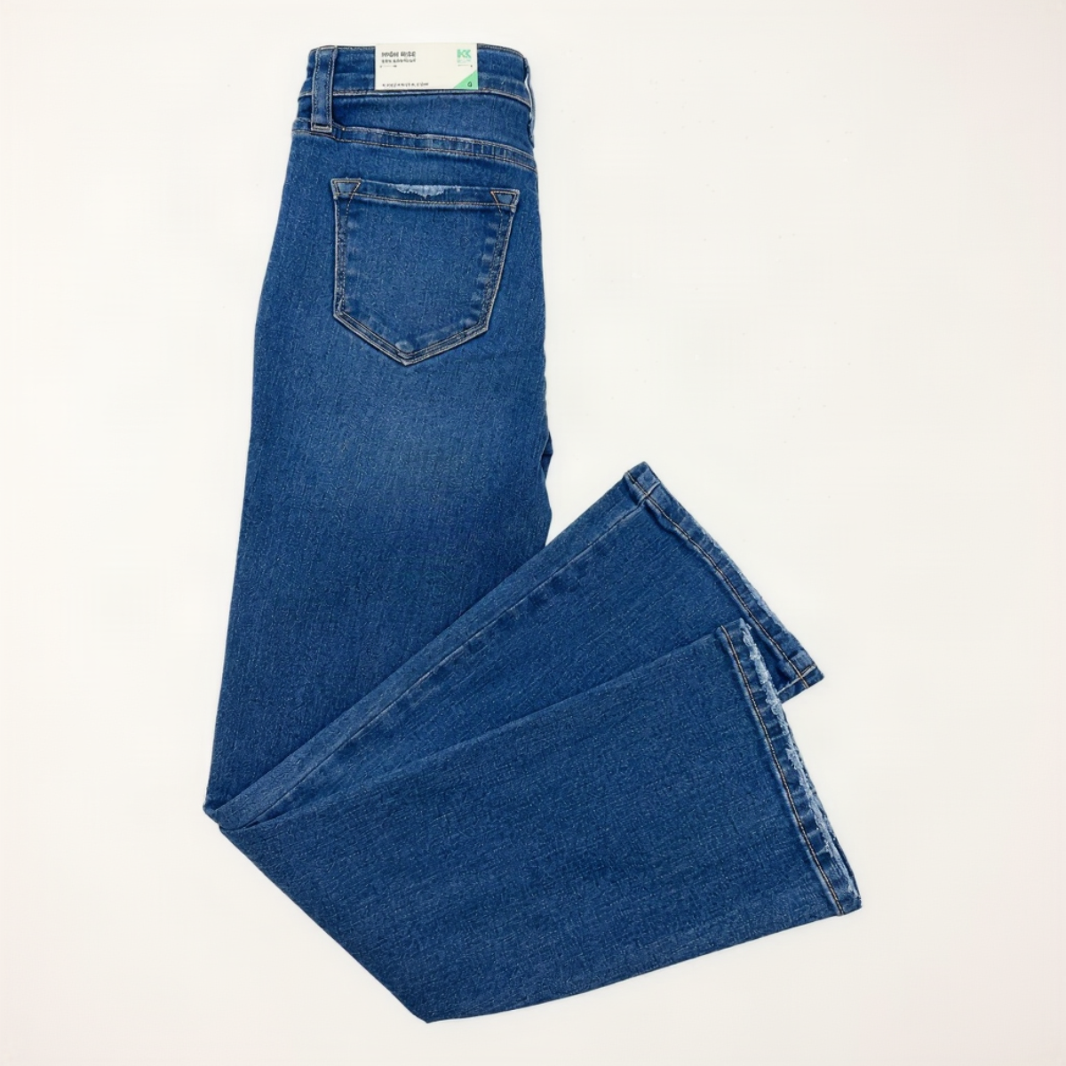 A pair of medium blue denim jeans folded to show the back pocket and leg construction, photographed on a plain white background.