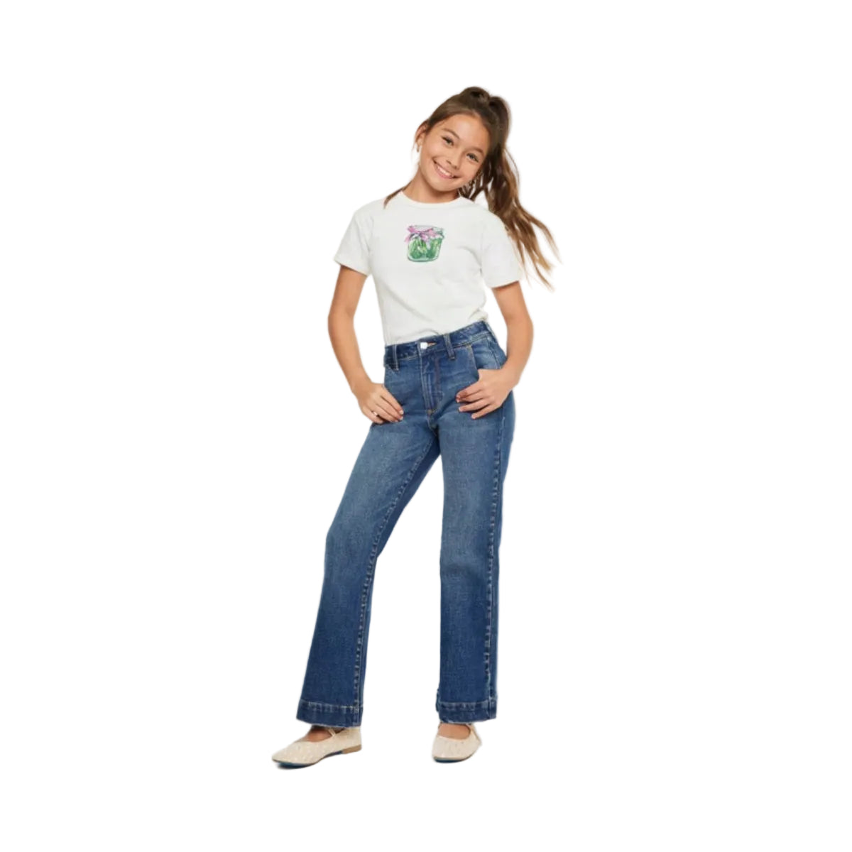 Young girl wearing a white t-shirt with a graphic design and blue jeans on a white background
