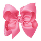 Large hot pink grosgrain classic hair bow with double knot center.