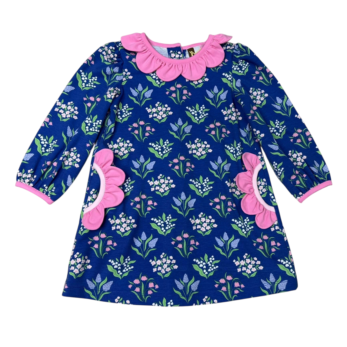 A girls' long-sleeve dress with a navy blue background and a vivid floral print, featuring a prominent pink petal trim on the pockets and neckline and pink trim on the cuffs.