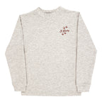 A light heather beige crewneck sweatshirt with an embroidered J. Bailey logo and turkey tracks.