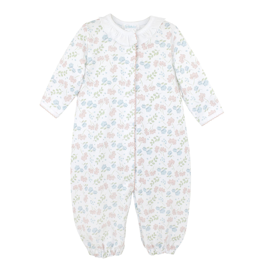 Baby girl’s Pima cotton converter gown with white ruffle neckline and pink and blue floral Liberty-inspired print on white background.