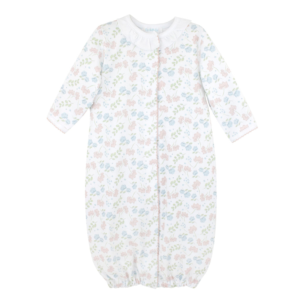 Baby girl’s Pima cotton converter gown with white ruffle neckline and pink and blue floral Liberty-inspired print on white background.