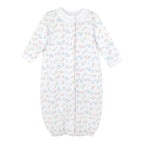 Baby girl’s Pima cotton converter gown with white ruffle neckline and pink and blue floral Liberty-inspired print on white background.
