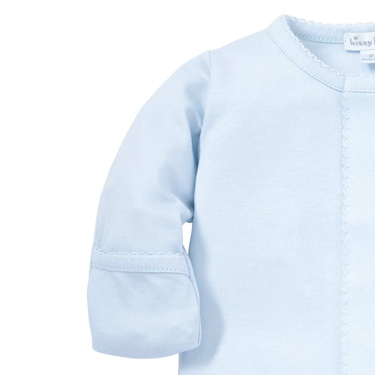 Closeup of a light blue baby boy footie sleeper showing foldover mittens and Kissy Kissy tag