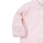 Close-up of a baby gown in light pink, showing the sleeve cuff and white picot trim.