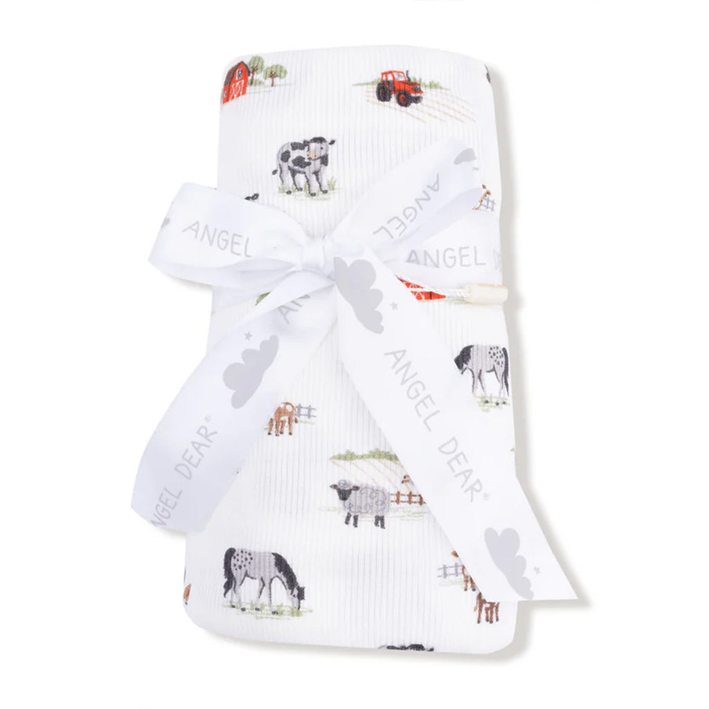 Baby swaddle blanket in ultra soft ribbed modal fabric with a farm animal print tied in a white 'Angel Dear' ribbon.