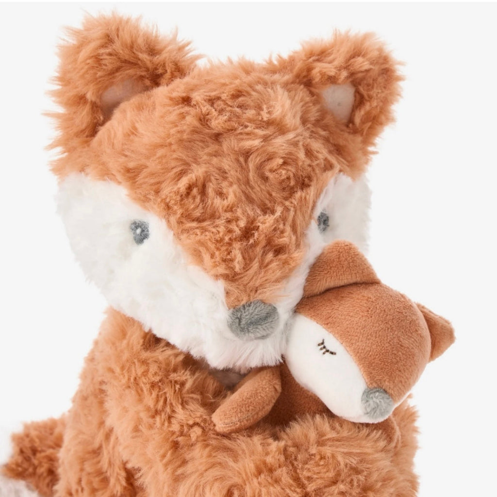 Plush toy fox with a white muzzle and a baby fox