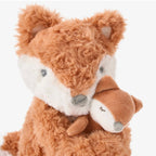 Plush toy fox with a white muzzle and a baby fox
