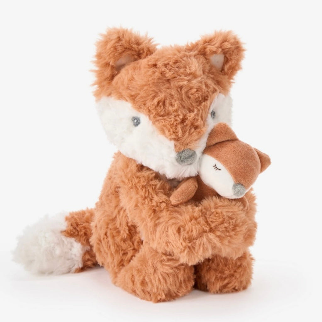 Plush toy fox with a smaller fox in its arms