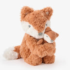 Plush toy fox with a smaller fox in its arms