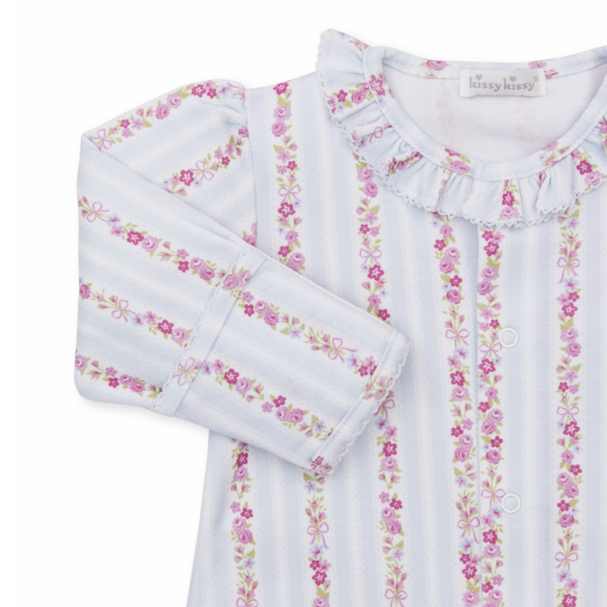 A baby girl long-sleeve converter gown closeup with a Kissy Kissy brand label featuring light blue and white vertical stripes with pink floral and bow patterns and a ruffled collar.