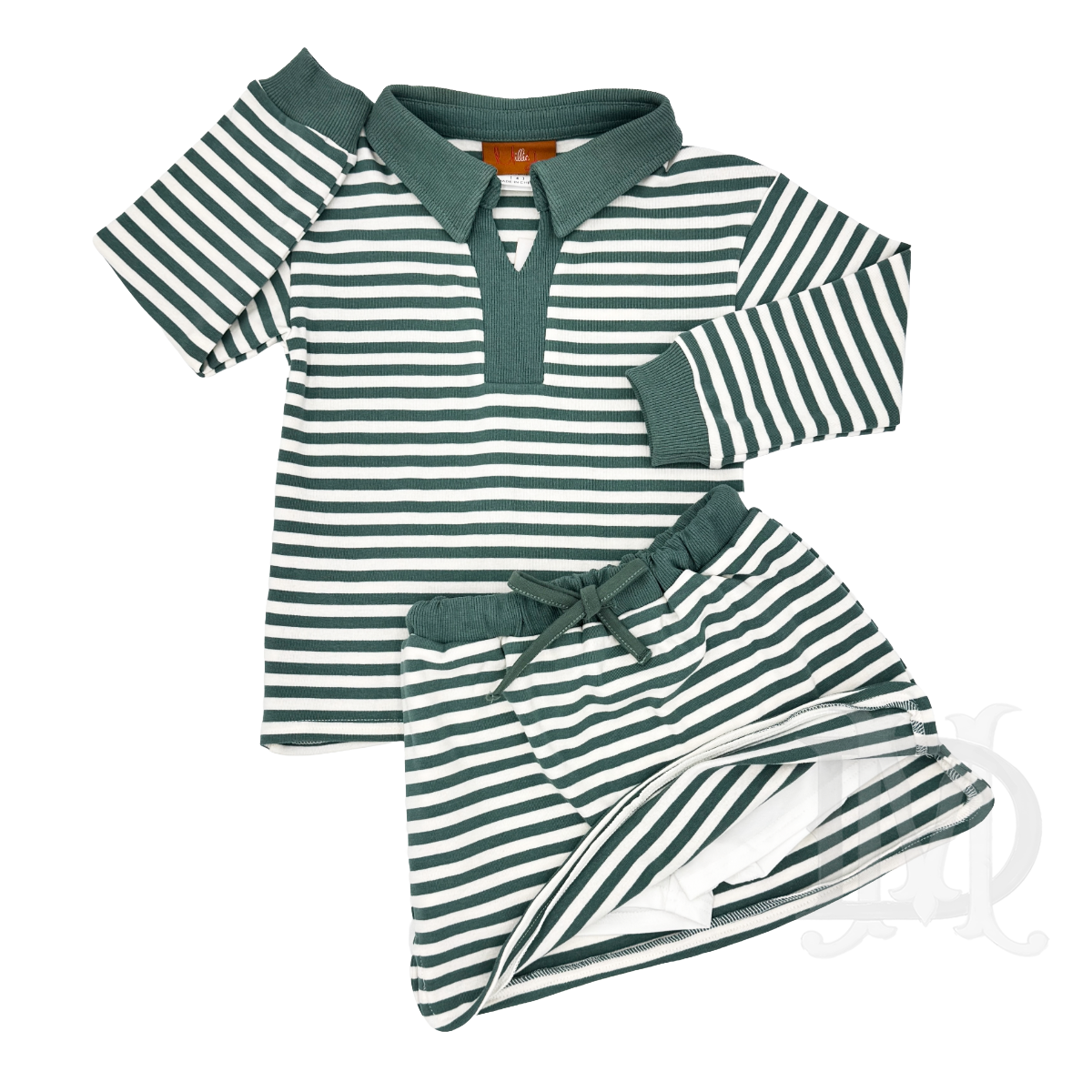A two-piece girl's outfit featuring a long-sleeve green and white striped top and matching skirt and solid green trim on the collar, sleeve cuffs, and built-in shorts.
