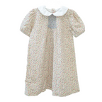 Little girl short sleeve dress with fall floral print, white Peter Pan collar, puff sleeves, and smocked chest panel in blue embroidery.