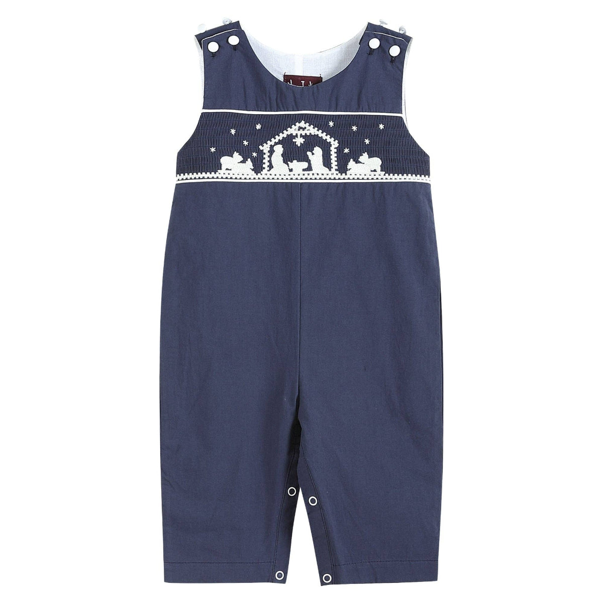 A navy blue baby romper with white embroidered details across the chest depicting a nativity scene under stars, shown on a plain white background.