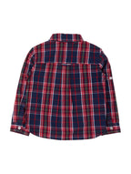 A long-sleeve plaid button-up shirt shown from the back, featuring a navy blue base with red, green, and white intersecting stripes, laid flat against a light gray background.