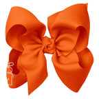 Large orange grosgrain classic hair bow with double knot center.