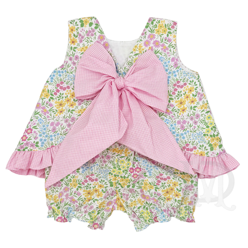 Back view of a bright summer floral little girl bloomer set with a pink check ruffled hem and a large pink gingham bow.
