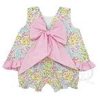 Back view of a bright summer floral little girl bloomer set with a pink check ruffled hem and a large pink gingham bow.