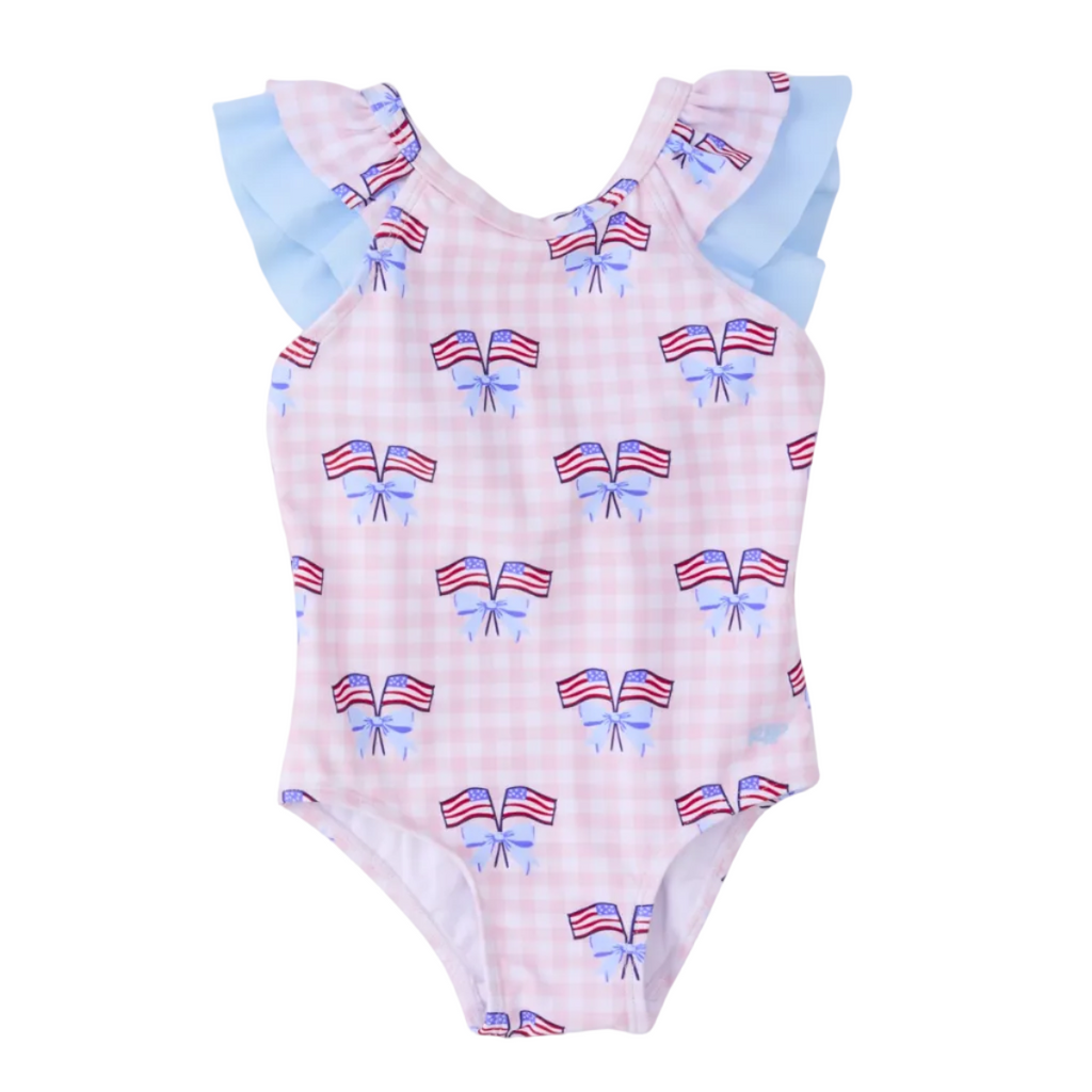 Girl’s one piece patriotic bathing suit with bow and American flag pattern on a pink gingham check background with blue ruffle sleeves.