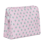 A pink and green floral print cosmetic pouch travel bag with a white zipper pull.
