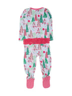 A baby's long-sleeve footed pajama set featuring a festive Christmas print with snowmen, trees, and candy canes on a white background, with a pink fuzzy waistband and pink polka-dot foot cuffs.