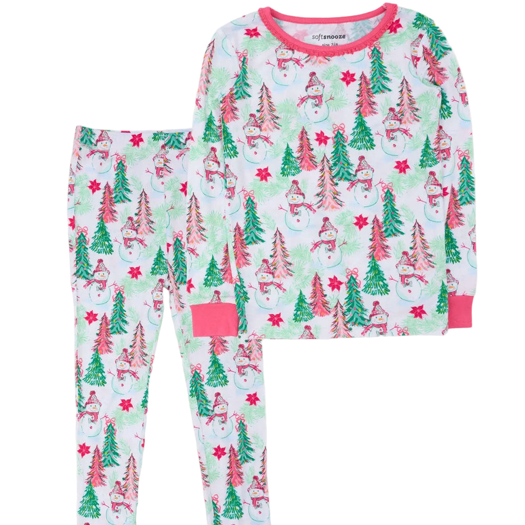 A two-piece children's pajama set featuring a long-sleeve top and matching pants with a festive Christmas print of snowmen, pine trees, and snowflakes on a white background, accented with pink trim.