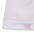 Close-up of a light pink and white striped newborn beanie cap with a white cuff and a pink embroidered bow with tiny green flower details.