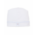 A white knit newborn baby girl hat featuring a light blue scalloped trim and a small embroidered bow with a pink rose center.