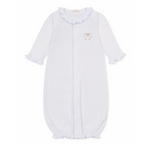 A white long-sleeve baby girl sleep sack with ruffled collar and cuffs, light blue trim and a delicate embroidered bow with pink rosettes. 